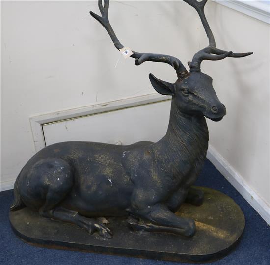 A large bronzed metal model of a recumbent stag H.88cm